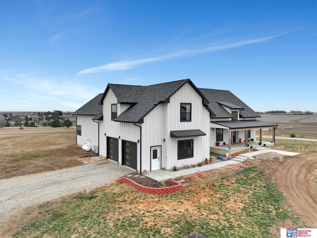 view of front facade with a porch, a garage, and a front lawn