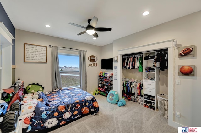 carpeted bedroom with ceiling fan and a closet