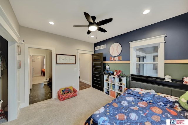 bedroom featuring ceiling fan and carpet