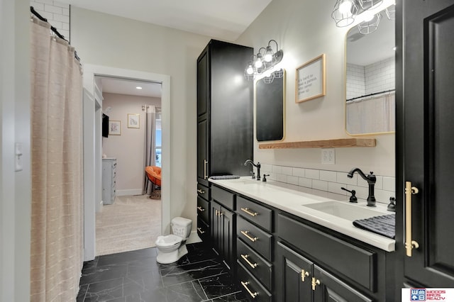 bathroom featuring decorative backsplash and vanity