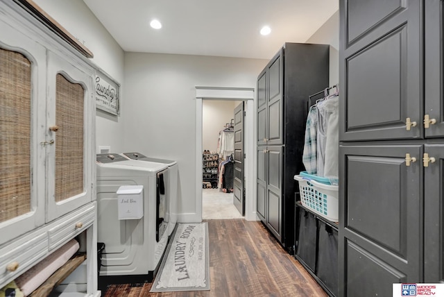 washroom with washing machine and dryer and dark hardwood / wood-style floors