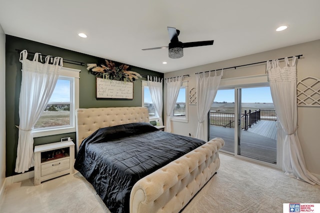 carpeted bedroom featuring multiple windows, access to outside, and ceiling fan