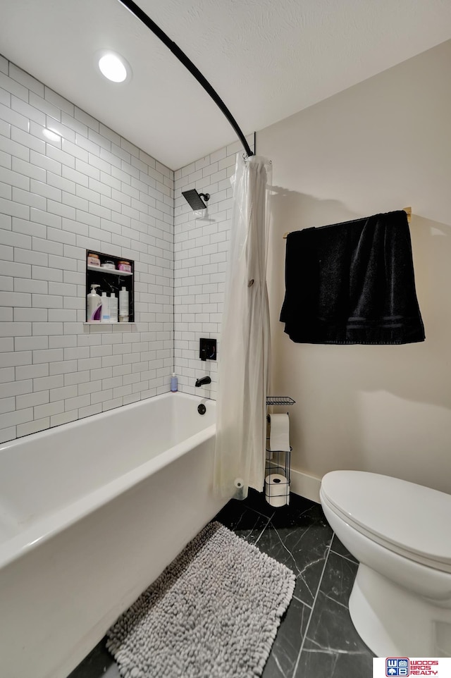 bathroom with shower / bath combo and toilet