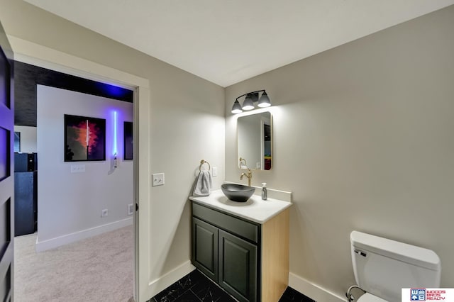 bathroom featuring vanity and toilet