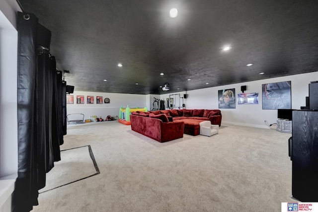 home theater room with light colored carpet