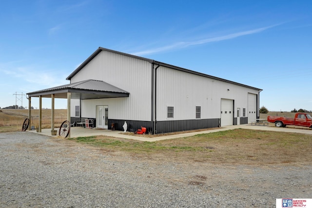 view of side of home with a garage and an outdoor structure