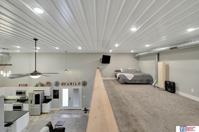 bedroom with ceiling fan, stainless steel fridge with ice dispenser, and french doors