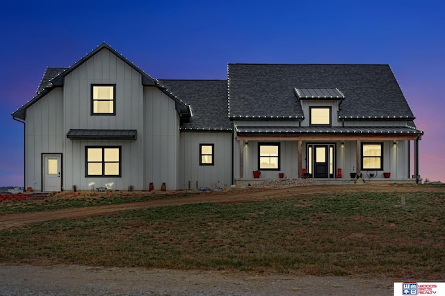 modern inspired farmhouse featuring a lawn and a porch