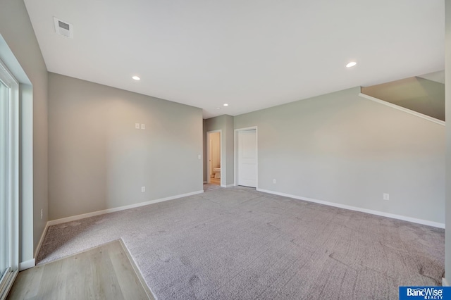 empty room featuring light colored carpet