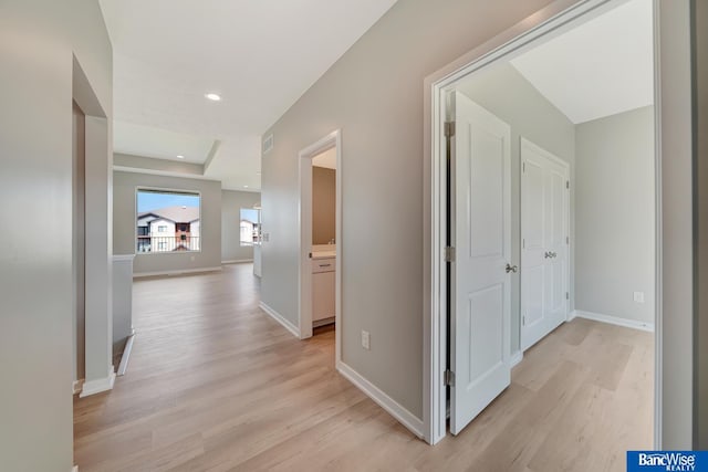 hallway with light hardwood / wood-style flooring