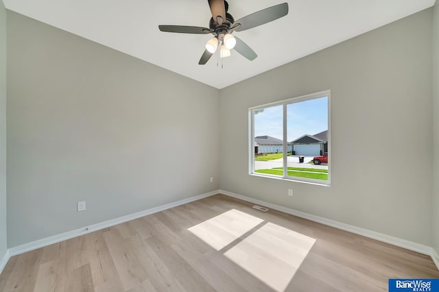 spare room with ceiling fan and light wood-type flooring