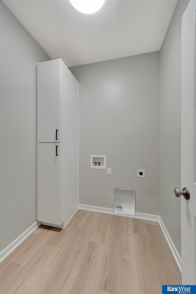 laundry area with hookup for an electric dryer, light hardwood / wood-style floors, and hookup for a washing machine