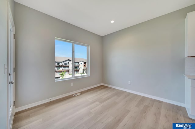 empty room with light hardwood / wood-style flooring