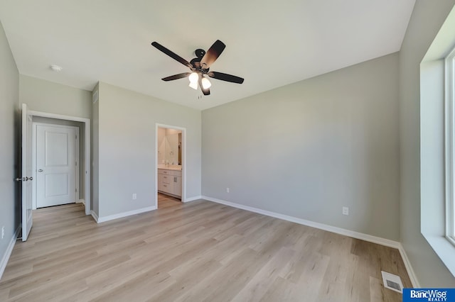 unfurnished bedroom with connected bathroom, light hardwood / wood-style flooring, and ceiling fan