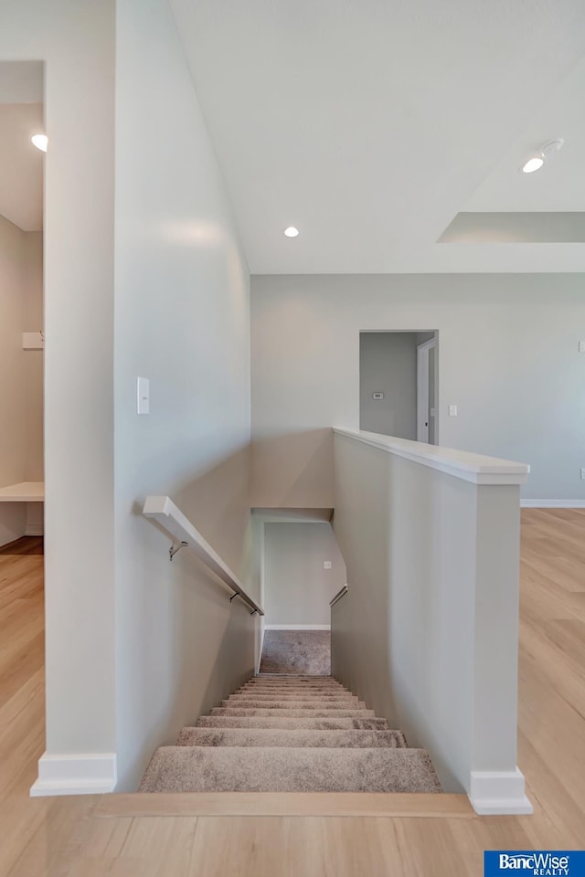 stairs featuring hardwood / wood-style floors