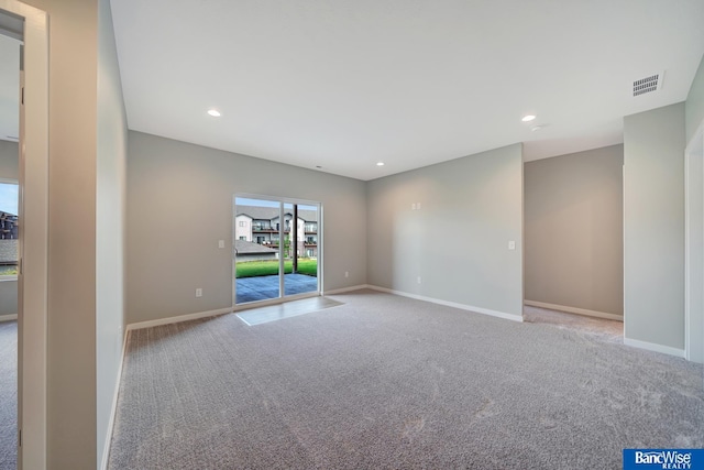 spare room featuring light carpet