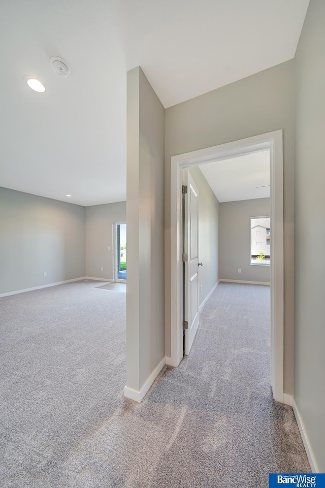 hall featuring light colored carpet