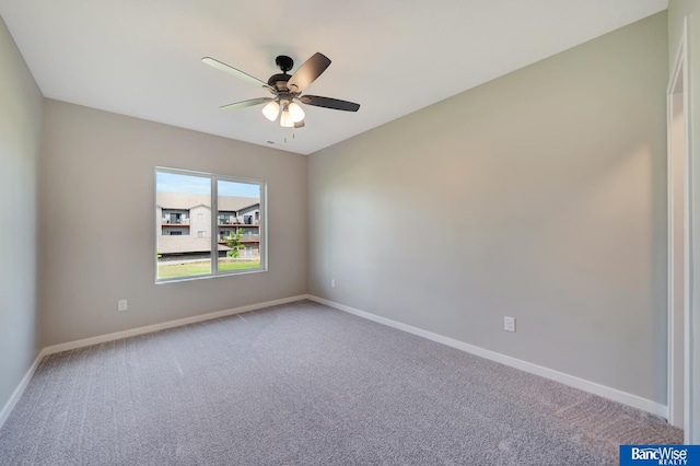 spare room with carpet floors and ceiling fan