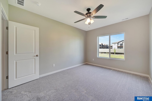 unfurnished room featuring light carpet and ceiling fan