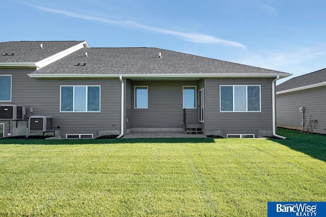 rear view of house with a yard, a patio, and central air condition unit