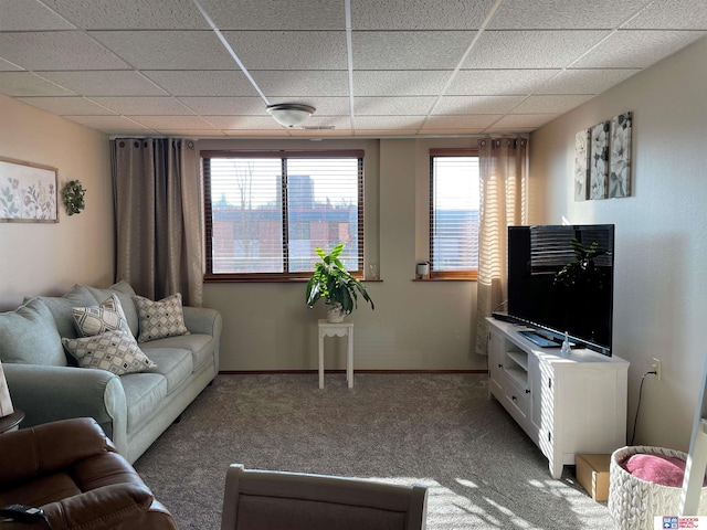 carpeted living room with a drop ceiling