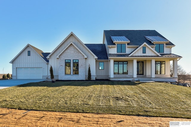 modern farmhouse style home with a garage, a front lawn, and covered porch