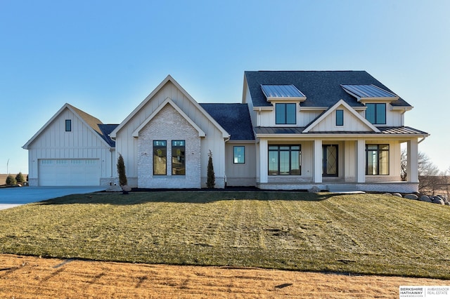 modern farmhouse style home with a garage, a front lawn, and covered porch