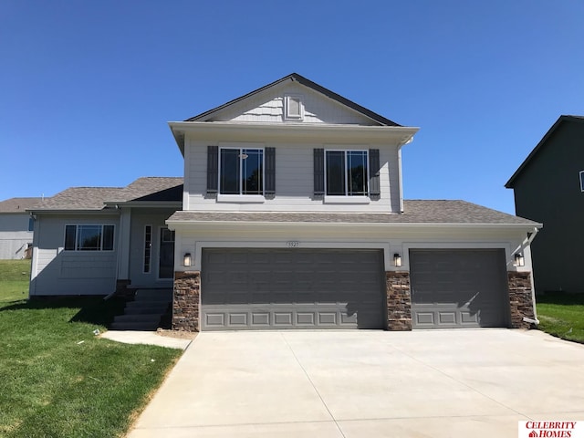 view of front of house featuring a garage and a front lawn