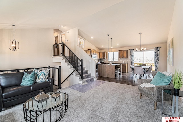 carpeted living room with a notable chandelier, lofted ceiling, and sink