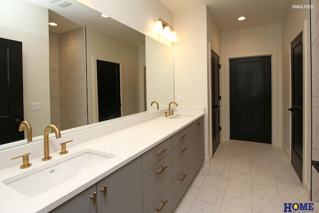 full bath featuring marble finish floor, double vanity, a sink, and recessed lighting