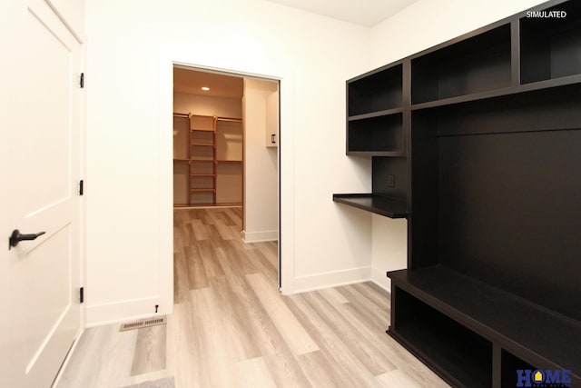 mudroom featuring light wood-style floors, visible vents, and baseboards