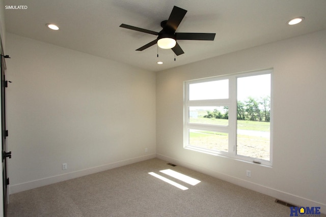 carpeted empty room with recessed lighting, visible vents, and baseboards