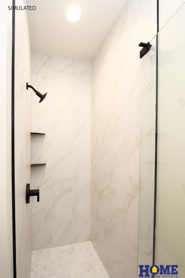 full bath featuring a marble finish shower