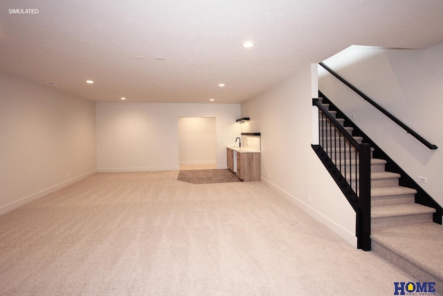 finished basement featuring light carpet, stairway, baseboards, and recessed lighting