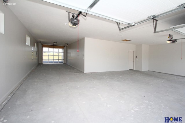 garage with baseboards and a garage door opener