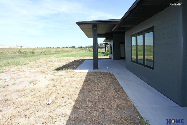 view of yard with a patio and a rural view