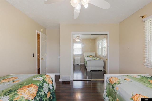 bedroom featuring ceiling fan, dark wood-type flooring, and a closet