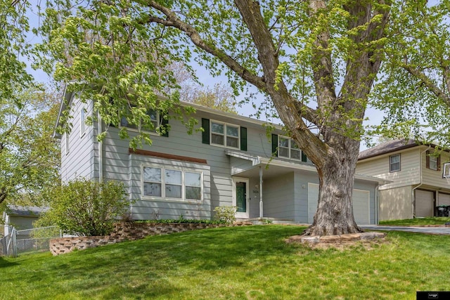 view of front of home featuring a front yard and a garage