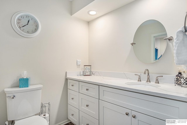 bathroom featuring vanity and toilet