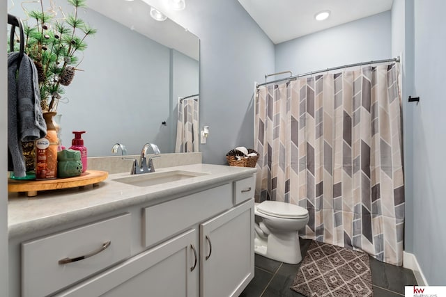 bathroom featuring tile patterned floors, vanity, toilet, and walk in shower