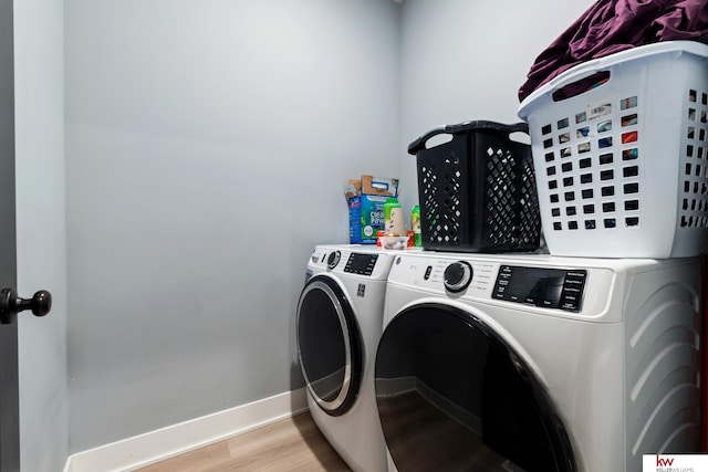 laundry room featuring light wood-type flooring and washing machine and clothes dryer