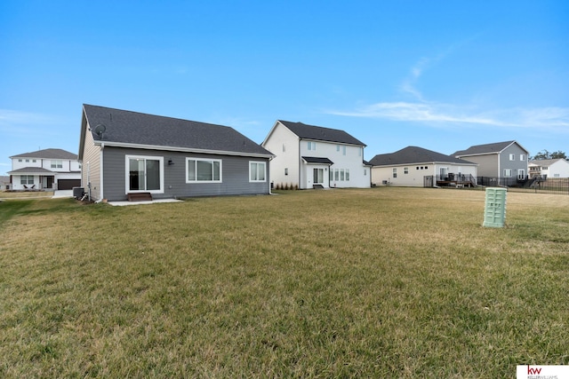 rear view of house with a lawn