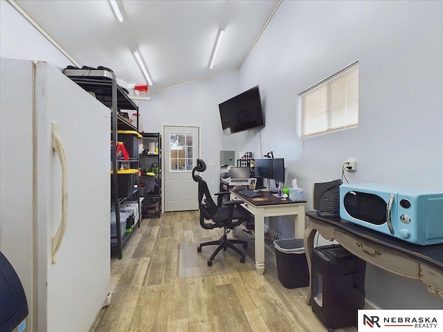 office area featuring lofted ceiling, light wood-type flooring, and ornamental molding