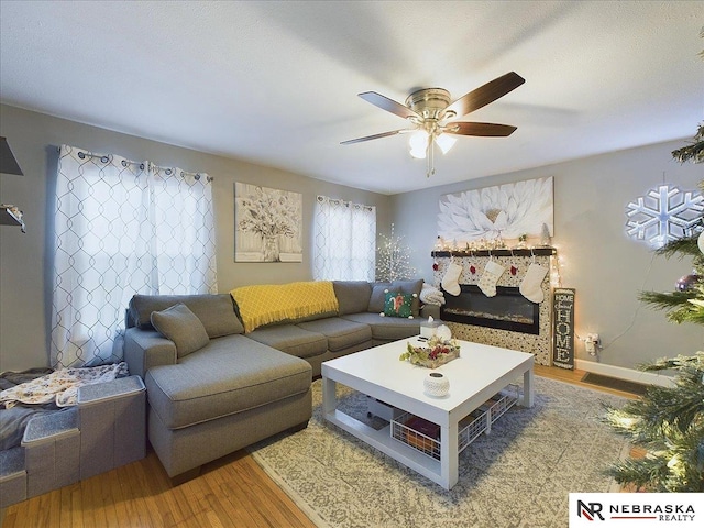 living room featuring hardwood / wood-style floors and ceiling fan