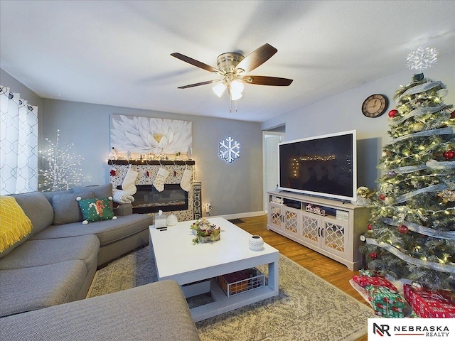 living room with ceiling fan and hardwood / wood-style floors