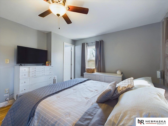 bedroom with hardwood / wood-style flooring and ceiling fan