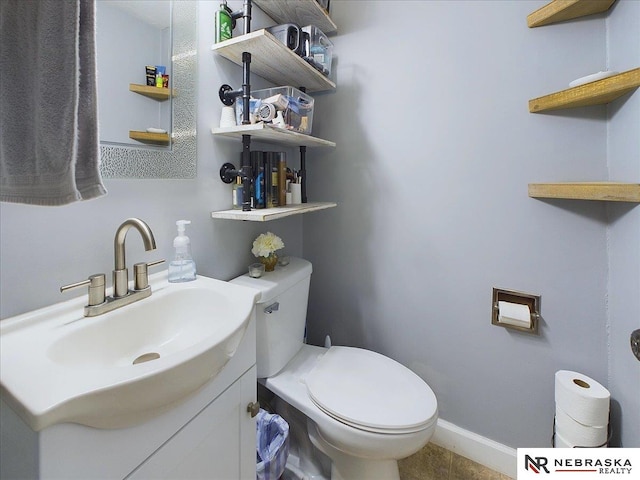 bathroom with tile patterned floors, vanity, and toilet