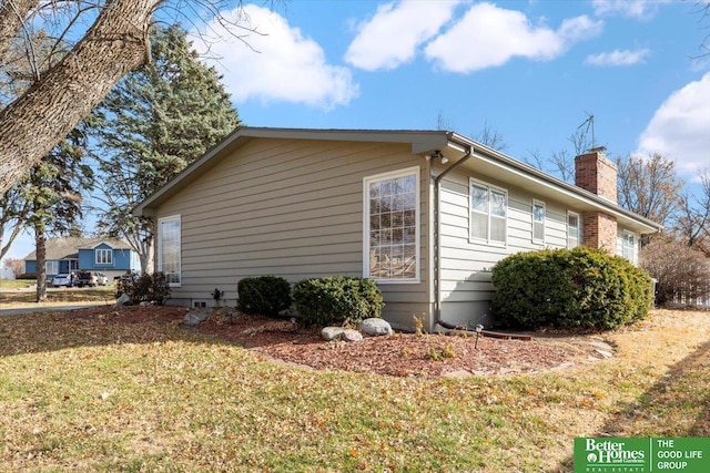 view of property exterior with a yard