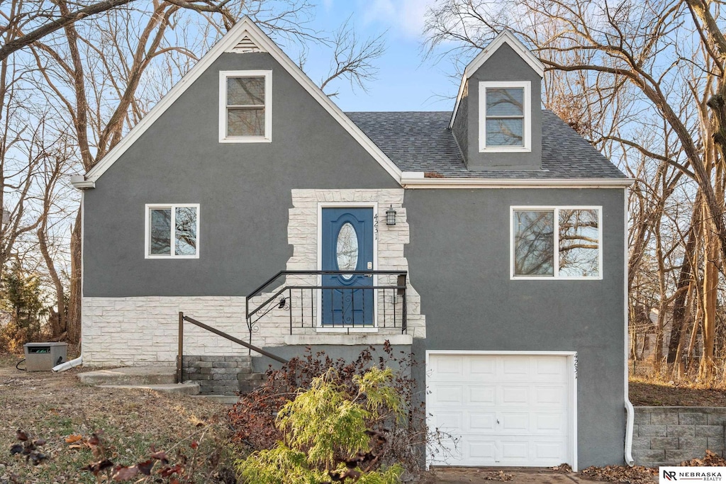 view of front of house with central AC and a garage