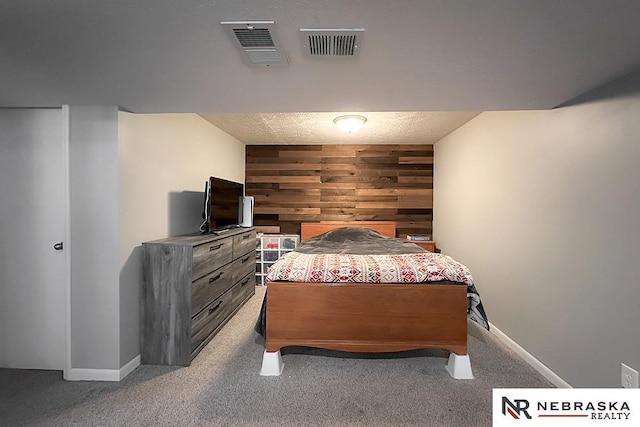 bedroom with wooden walls and carpet